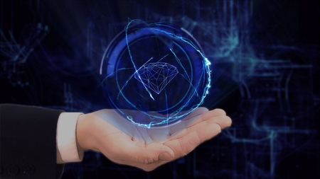 Painted hand shows concept hologram 3d diamond on his hand. Drawn man in business suit with future technology screen and modern cosmic backgroundの写真素材