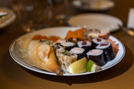 Sushi and rolls on a plate in a restaurant. Selective focus.の写真素材