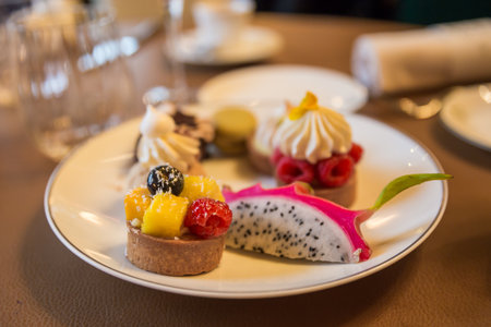 Desserts in a restaurant on a white plate on the tableの写真素材