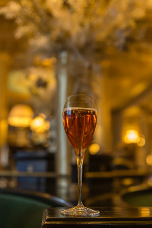 Wine glass on table in restaurant, shallow depth of field.の写真素材