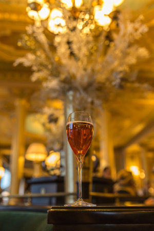 Wine glass on table in restaurant. Selective focus and shallow depth of field.の写真素材