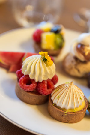 Fruit tartlets on a white plate. Selective focus.の写真素材