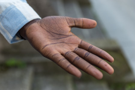 Close up of a hand of a man in a blue shirt.の写真素材
