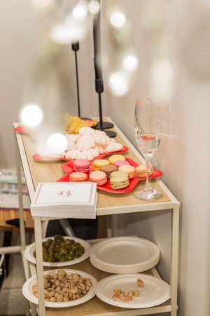 Dining table with French macarons and wine in a restaurantの写真素材