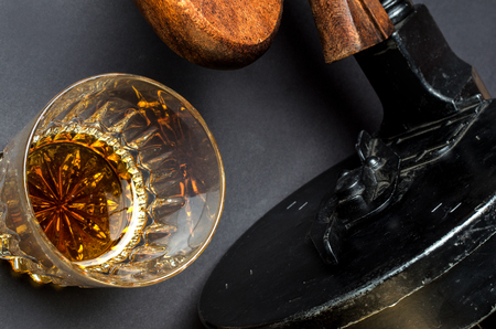 Thompson gun and whiskey glass on black backgroundの写真素材
