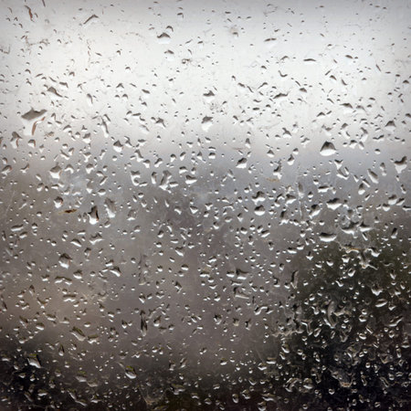 In the evening, the rain on the windowpane. Use as a background. Low depth of focus.