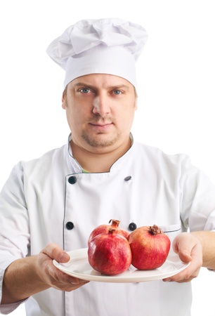 cook in uniform with pomegranates, selective focusの写真素材
