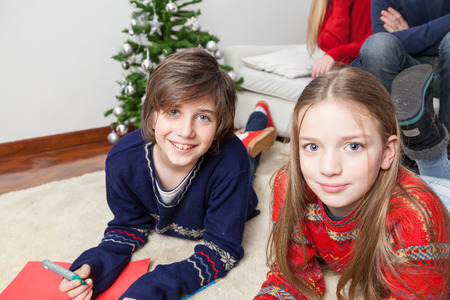 Brothers lying on the carpetの写真素材