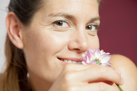 Woman smelling a flowerの写真素材