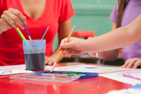 Teacher and student drawing with watercolorの写真素材