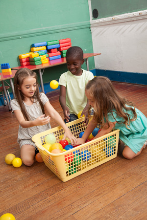 Students playing in kindergardenの写真素材