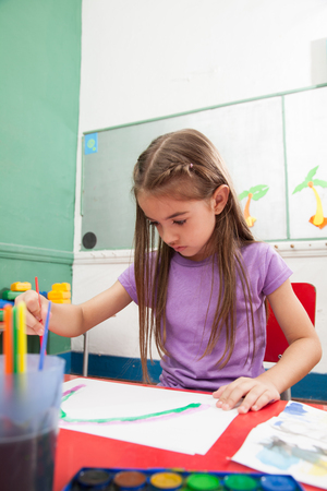 Pretty girl drawing in kindergardenの写真素材