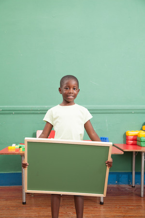 Black boy holding a blackboardの写真素材