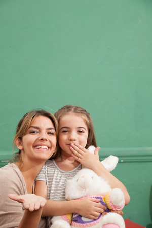 Young woman and girl sending kissesの写真素材