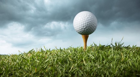close up of a golf ball on teeの写真素材