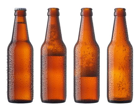 four bottles showing decreasing amount of beerの写真素材
