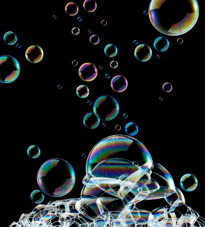 lots of soap bubbles against black backgroundの写真素材