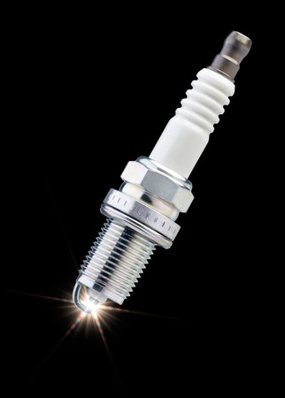 sparks on spark plug against black background