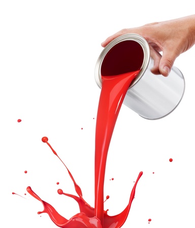 pouring red paint from its bucket creating splashの写真素材