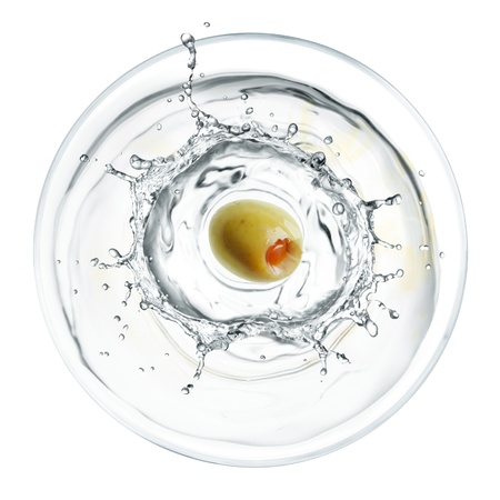 glass of splashing martini with olive from top viewの写真素材