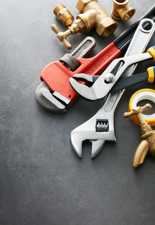 various type of plumbing tools on grey tileの写真素材