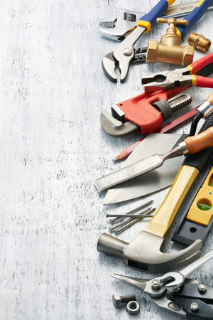 variety of tools on white textured background with copy spaceの写真素材