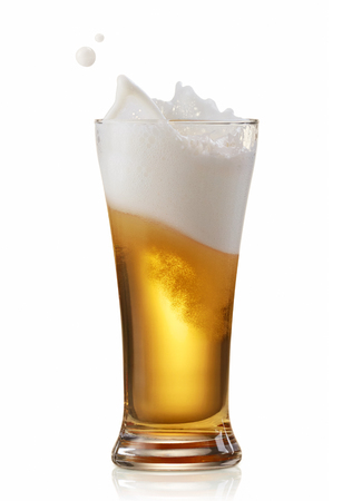 glass of splashing beer isolated on whiteの写真素材