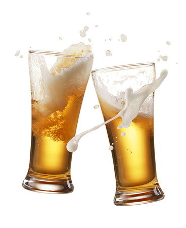 two glasses of beer toasting creating splashの写真素材