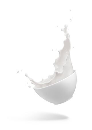 milk splashing out from dropping bowl isolated on whiteの写真素材
