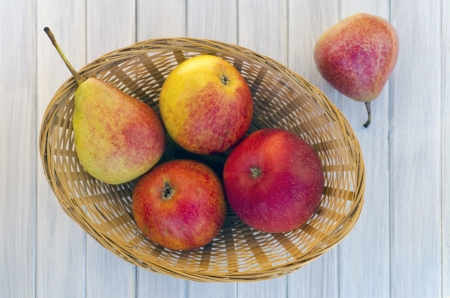 Pears and apples in a basketの写真素材