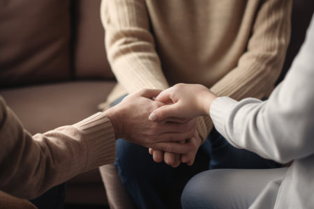 Two People Holding Hands While Sitting on a Couch, Couple hold hands to support each other while discussing family issues with a psychiatrist, AI Generatedの素材