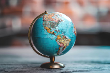 Blue and Gold Globe on Wooden Table, A visual representation of a globe with various languages to depict a language learning podcast, AI Generatedの素材