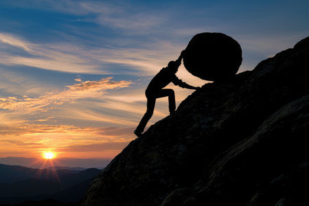 Person Climbing Up the Steep Rock Face of a Snow-Capped Mountain, Silhouette of a businessman pushing a boulder uphill symbolizing struggle in business, AI Generatedの素材