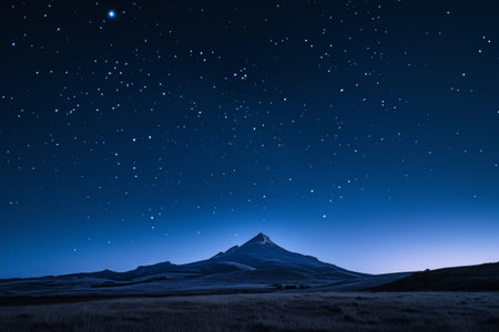 A photo of a mountain illuminated by the night sky adorned with countless stars, A tranquil moonlit sky with a distant solitary mountain, AI Generatedの素材