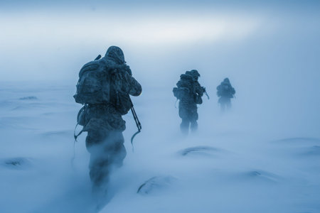 A group of men are walking across a snow covered field, making their way through the winter landscape, Special forces soldiers adapting to harsh arctic environment for survival training, AI Generatedの素材