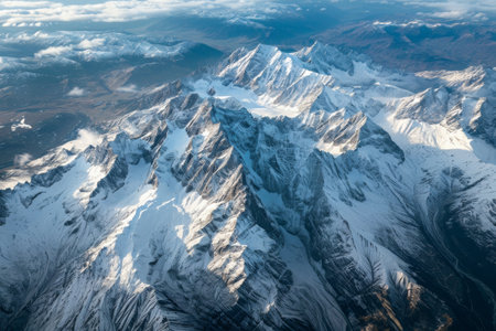 This photo captures an expansive aerial view of a snow-covered mountain range, showcasing the majestic peaks and valleys below, Majestic peaks of the Swiss Alps from a top-down view, AI Generatedの素材