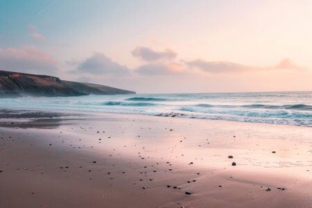 Waves gently rolling onto a sandy beach with a pastel sky in the background at sunset, A peaceful beach at sunset, with pastel skies and gentle waves crashingの素材