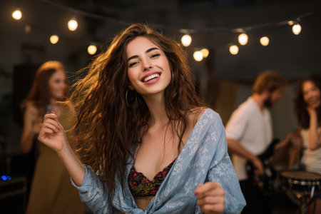 Dancing and enjoying music at a lively indoor gathering with friends in a cozy atmosphere filled with soft light and joyful energyの素材