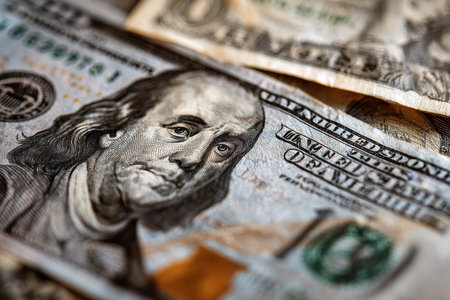 Realistic close-up of American banknotes showcasing intricate details and textures of currency with a focus on the ten-dollar bill and other denominationsの素材