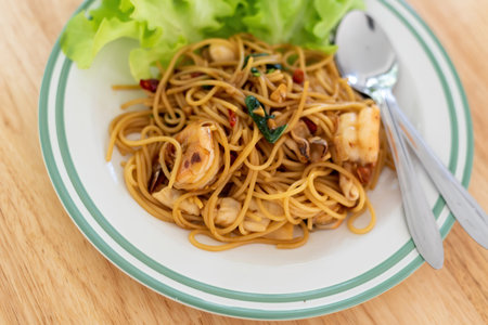 close up Spaghetti shrimp and vegetables on a wooden tableの写真素材