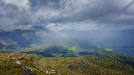 Distant rainbow in the mountains of Norway