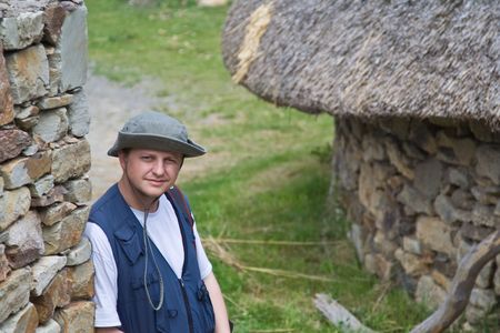 Young man resting against a stone wallの写真素材