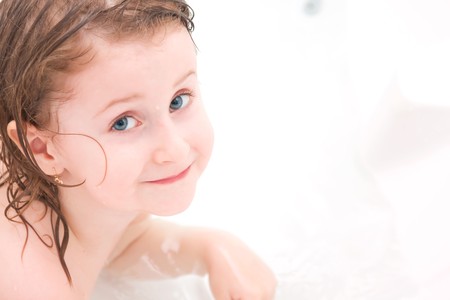 Little girl playing in the tub.の写真素材