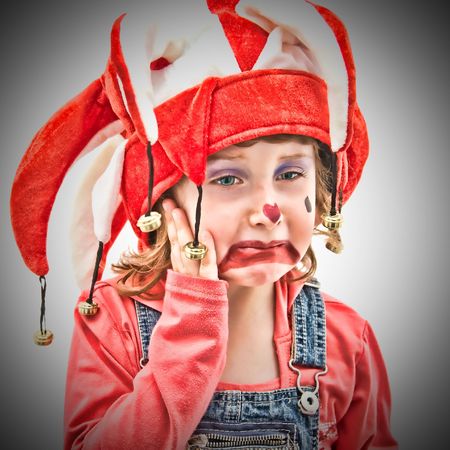 Little girl dressed as a buffon crying.の写真素材