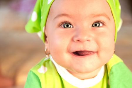 Beautiful baby girl dressed in greenの写真素材