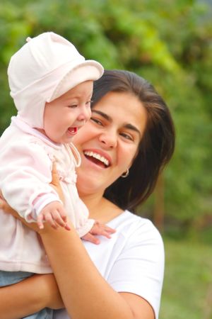 Baby girl and mother enjoying a day outside.の写真素材