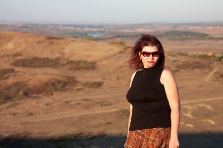 Beautiful woman portrait enjoying the nature at sunsetの写真素材