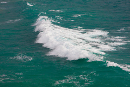 Big wave heading towards the shore in a sunny day.