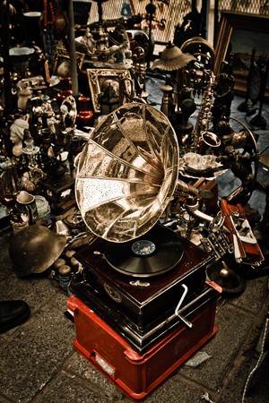 Antique gramophone between various old objects.の写真素材
