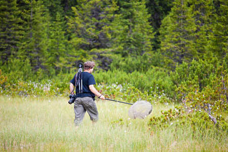 Biologist exploring a bog in Cindrel Mountains in Romania.